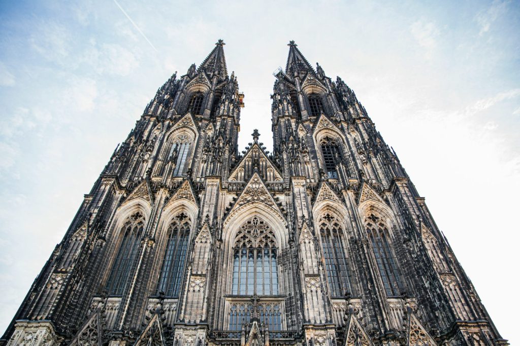 a large stone building with Cologne Cathedral in the background