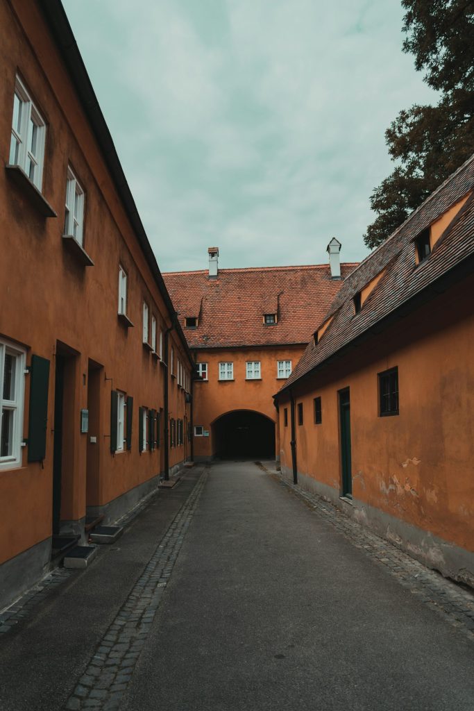 a narrow road next to a brick building